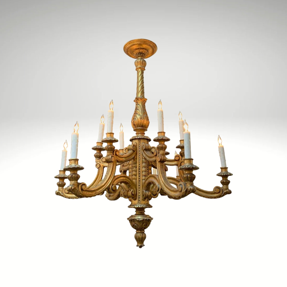 Vintage-style gilded wooden chandelier with detailed carvings, a central baluster stem, and ten electric candle sleeve lights.