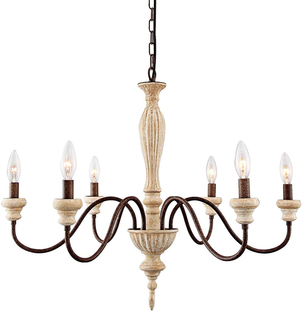 An elegant antique-style metal chandelier featuring sweeping curved arms, candle-style bulbs, and decorative crystal pendants illuminated by warm yellow light.