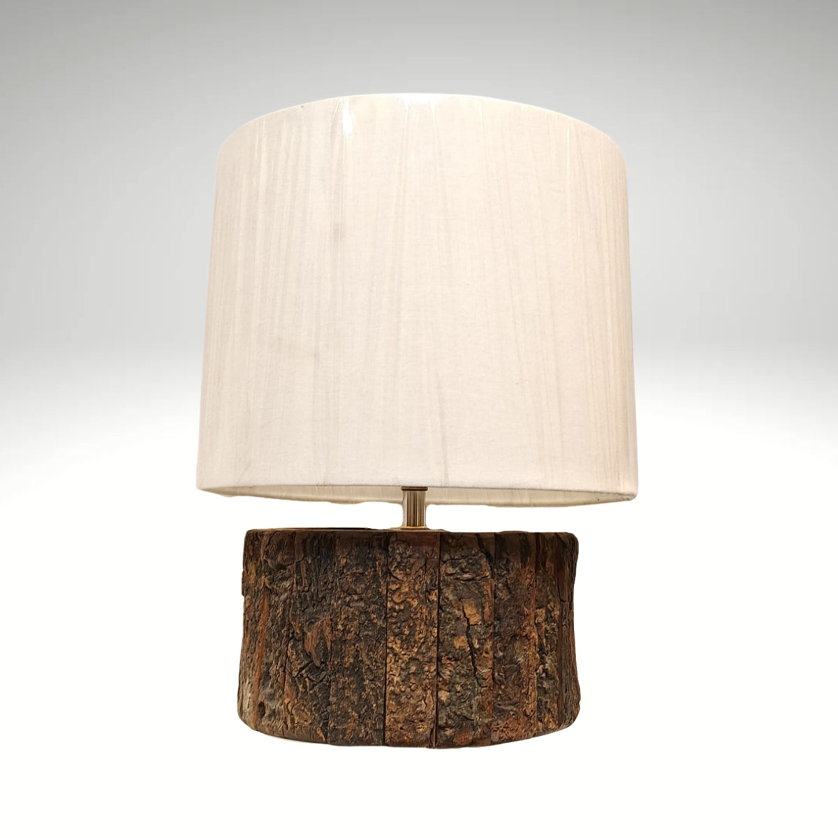A bohemian-style desk lamp crafted from a blocky, distressed wood baluster and a natural straw woven shade.