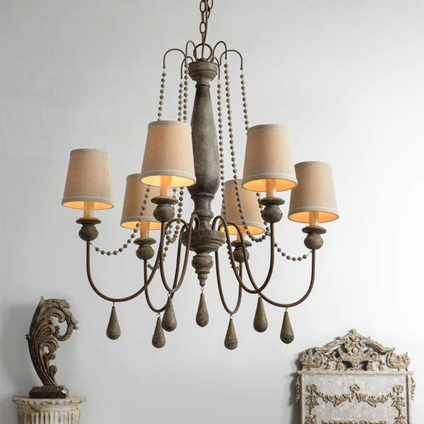 Rustic 6-light distressed wood chandelier with beige fabric shades and decorative beads.