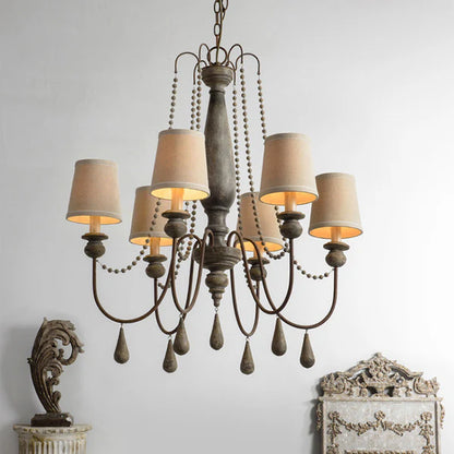 Rustic 6-light distressed wood chandelier with beige fabric shades and decorative beads.