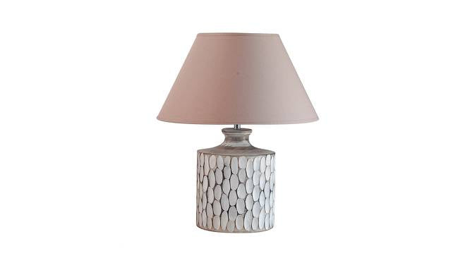 A rustic white ceramic table lamp featuring a textured, carved oval pattern on a cylindrical base with a beige fabric shade.