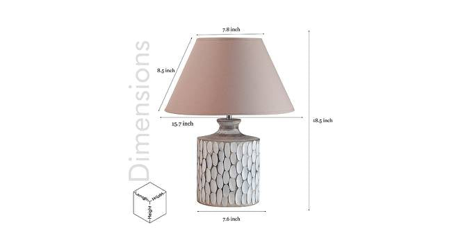 A rustic white ceramic table lamp featuring a textured, carved oval pattern on a cylindrical base with a beige fabric shade.