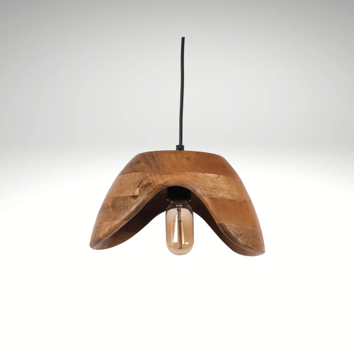 A modern hanging pendant light featuring a curved, wave-shaped natural mango wood shade with an exposed vintage Edison bulb.