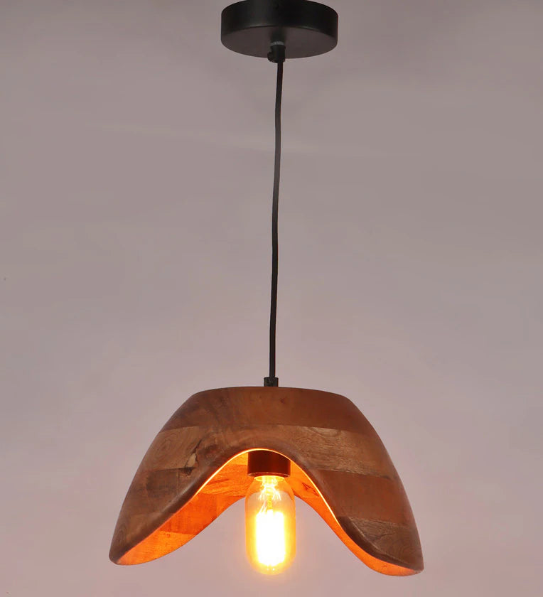 A modern hanging pendant light featuring a curved, wave-shaped natural mango wood shade with an exposed vintage Edison bulb.