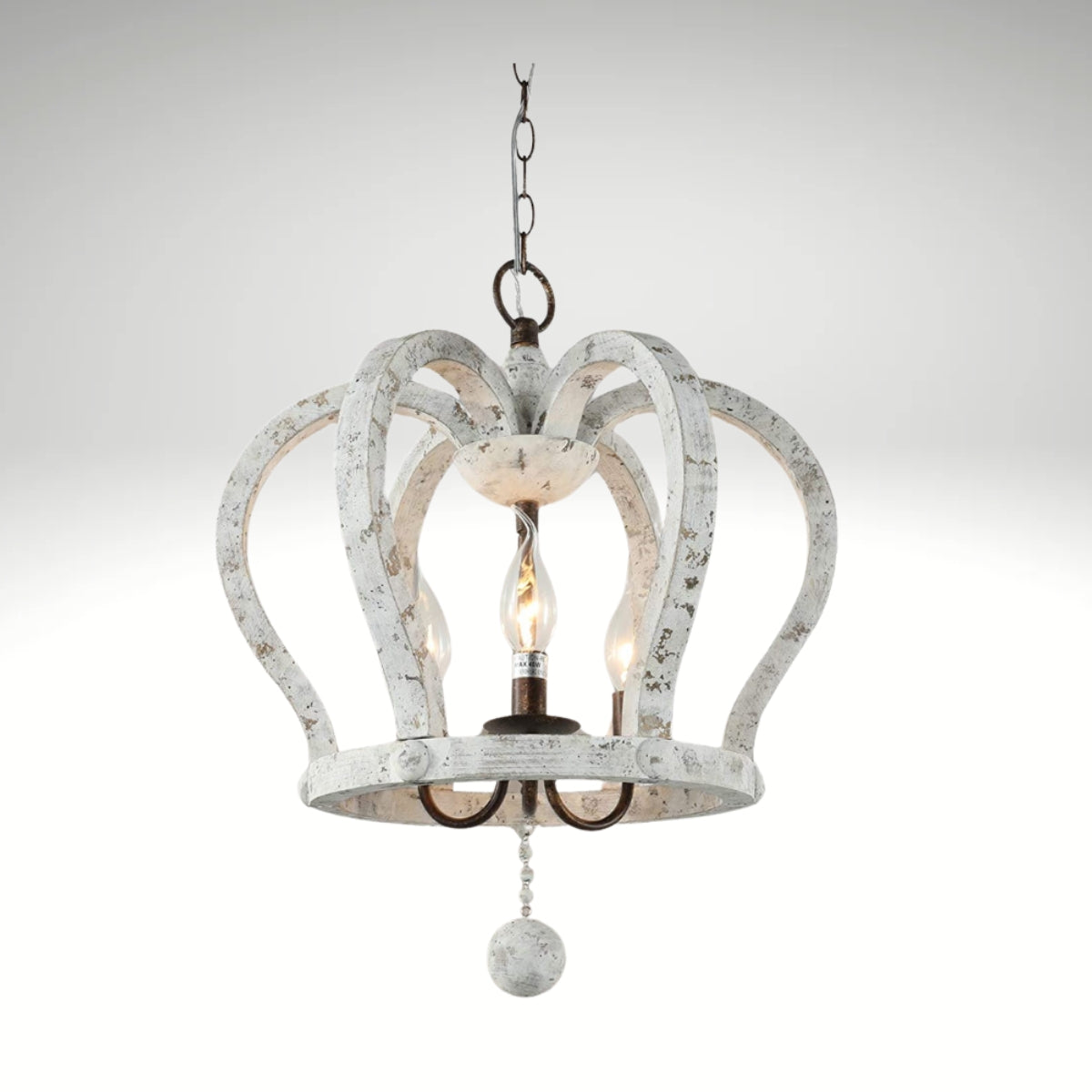 A 3-light crown-shaped chandelier with a distressed white wood finish hanging from a metal chain.