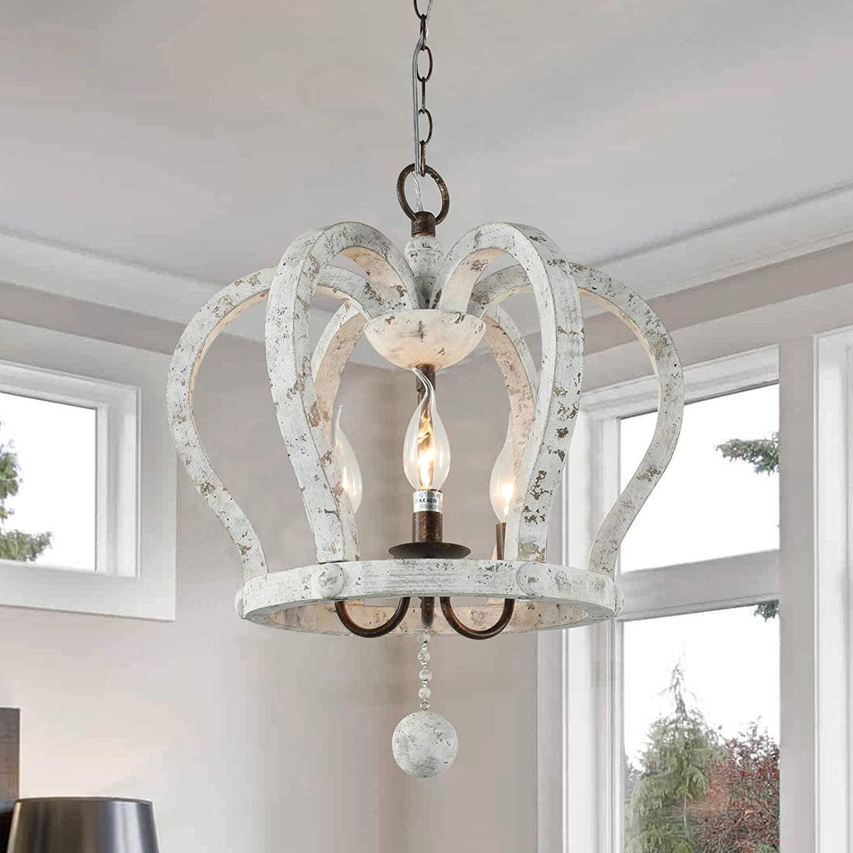 A 3-light crown-shaped chandelier with a distressed white wood finish hanging from a metal chain.