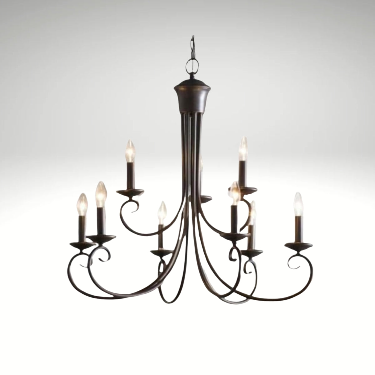 A classic 9-light metal chandelier with curved scrolling arms and candle-style bulbs