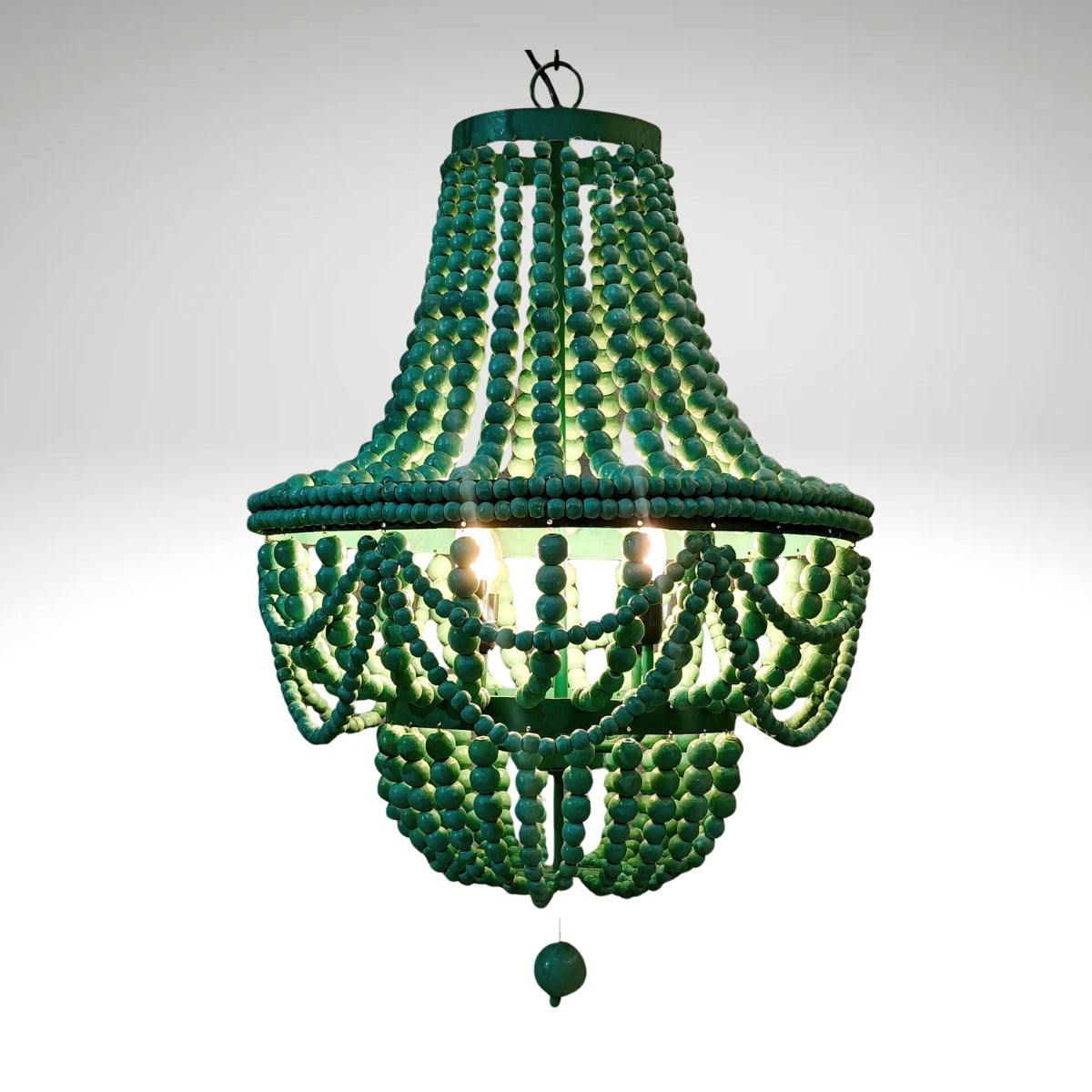 An empire-style chandelier crafted from vibrant green wooden beads.