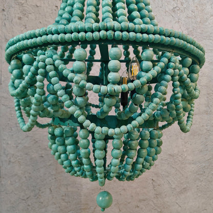 An empire-style chandelier crafted from vibrant green wooden beads