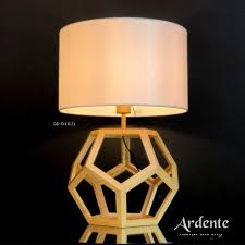Side table lamp featuring a hollow hexagonal wood frame base and a white empire shade.