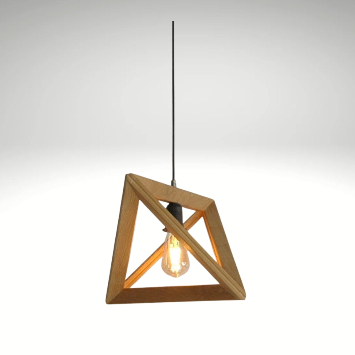 A minimalist pyramid-shaped wooden hanging lamp with a warm glowing light bulb.