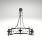 • Gothic style 3-bulb candle wall lamp in a black wrought iron finish, ideal for rustic hallways and traditional living spaces.