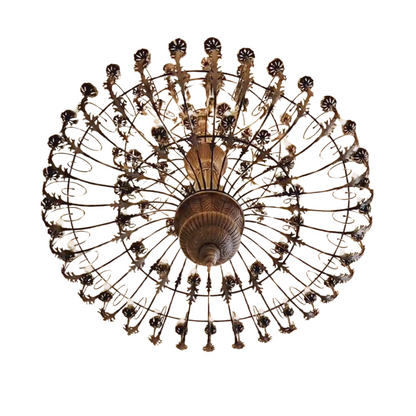 An antique bronze finish round chandelier featuring detailed leaf patterns, multiple small light bulbs, and a radial cage design.