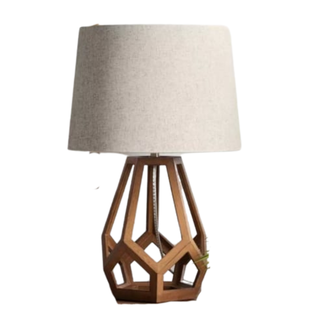 A modern table lamp featuring a brown geometric hollow wood base and a light beige fabric drum shade.