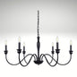 Matte black 6-light candle-style chandelier with curved arms hanging from a chain.