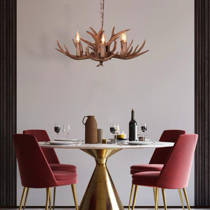 Faux antler pendant light with three lit candle-style bulbs, country style design.