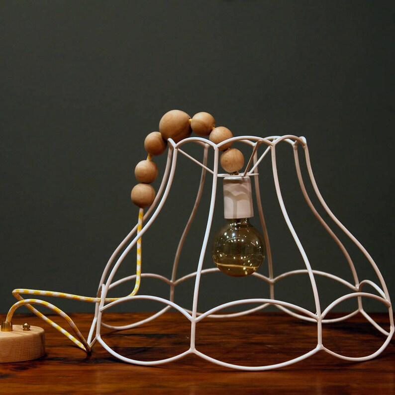 A rustic semi-flush mount ceiling light with a textured dome shade and a glowing bulb.