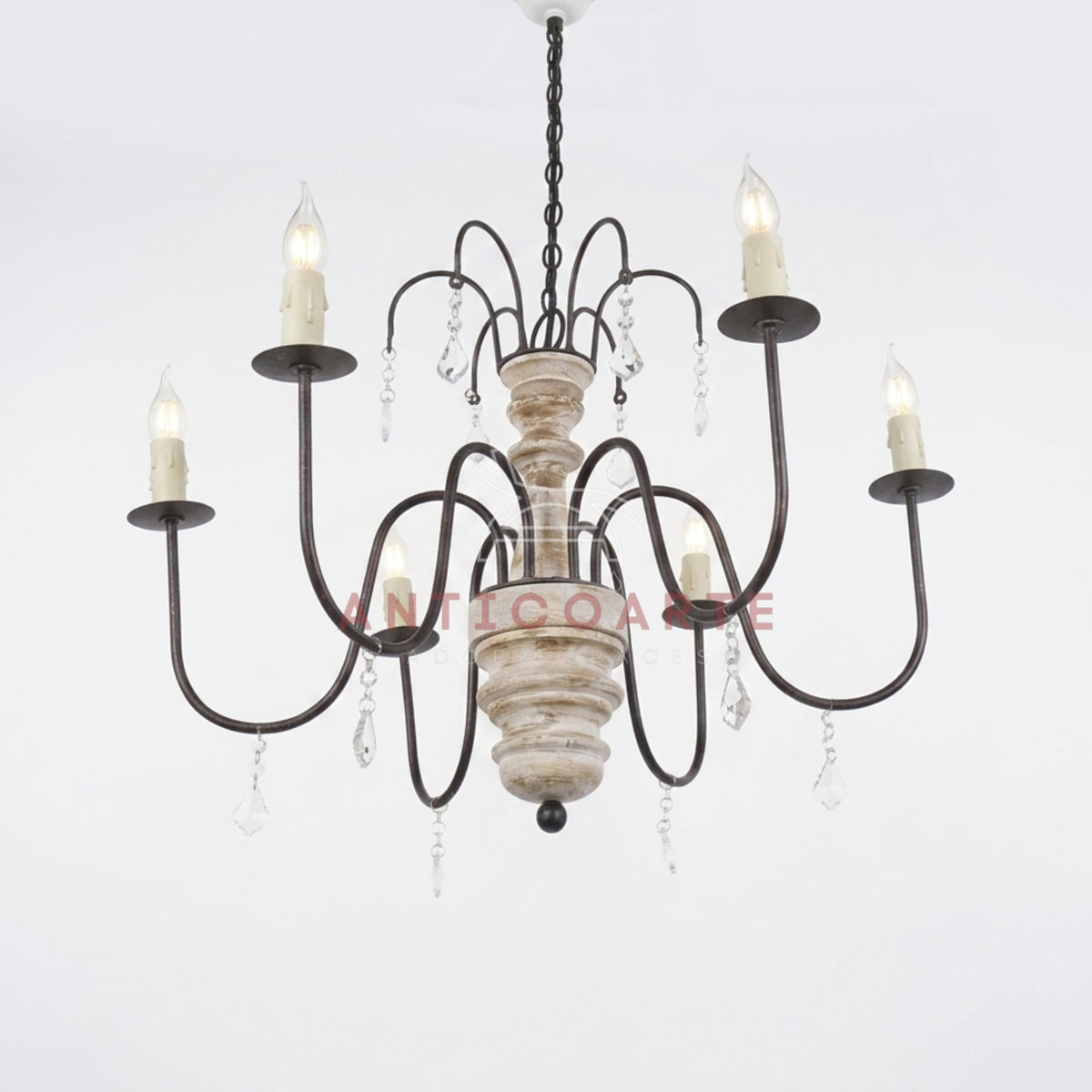Rustic 6-light candle chandelier with a distressed white wood spindle, curved bronze metal arms, and hanging crystal accents.