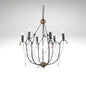 A 6-light candle-style chandelier featuring a black wrought iron cage frame, distressed bronze hardware accents, and delicate hanging crystal bead chains with teardrop pendants.
