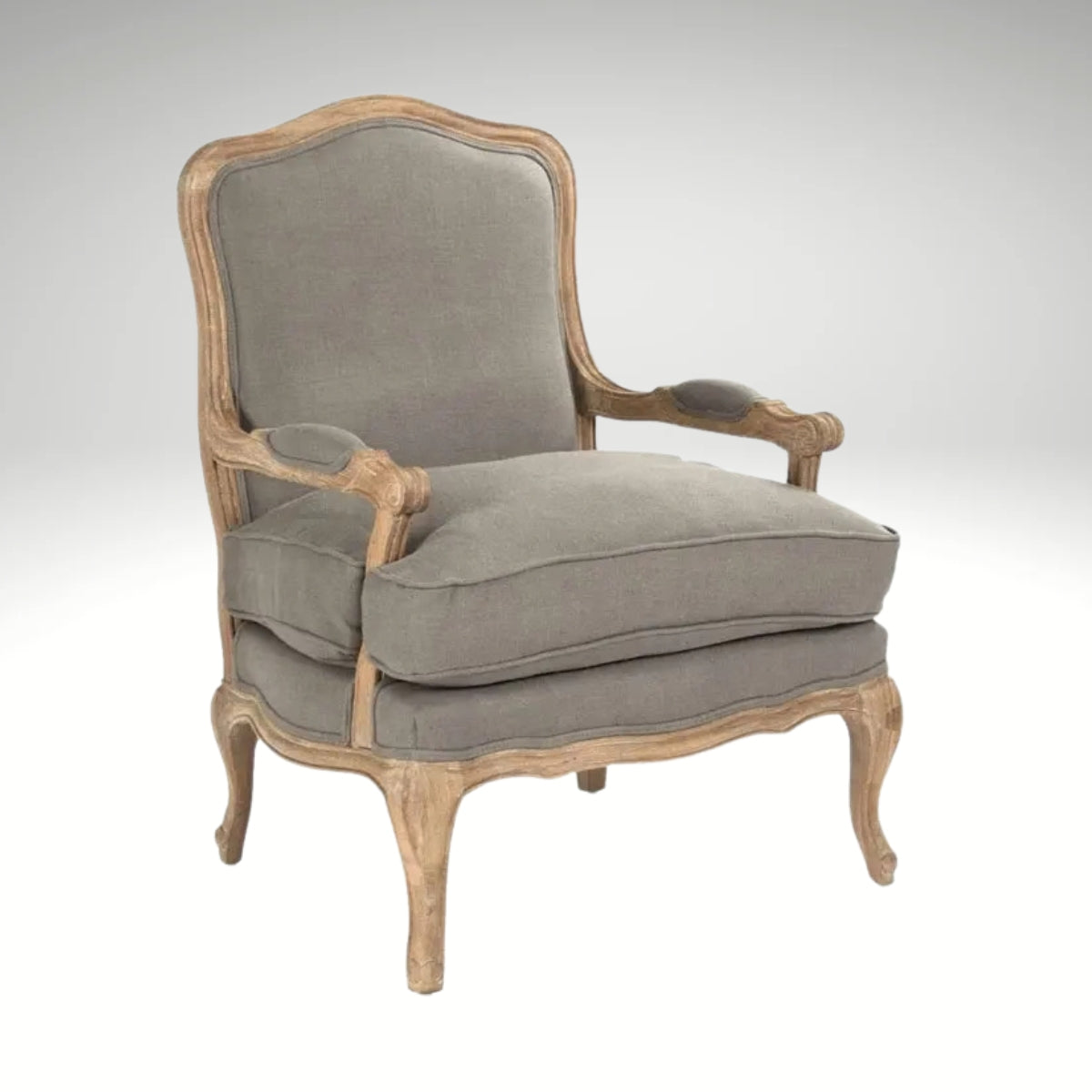 A classic French country style armchair with a weathered natural wood frame and comfortable grey linen upholstered cushions.