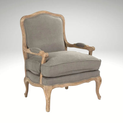 A classic French country style armchair with a weathered natural wood frame and comfortable grey linen upholstered cushions.