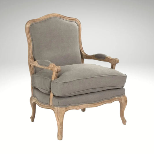 A classic French country style armchair with a weathered natural wood frame and comfortable grey linen upholstered cushions.