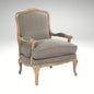 A classic French country style armchair with a weathered natural wood frame and comfortable grey linen upholstered cushions.