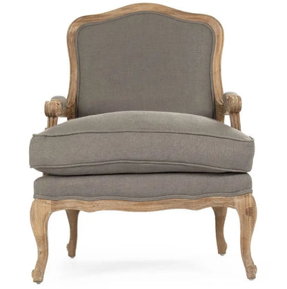 A classic French country style armchair with a weathered natural wood frame and comfortable grey linen upholstered cushions.