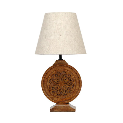 Bohemian-style table lamp with a round, carved wood mandala base and a neutral fabric lampshade