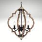 Rustic wooden globe pendant light fixture with four illuminated faux-candle bulbs hanging from a chain.