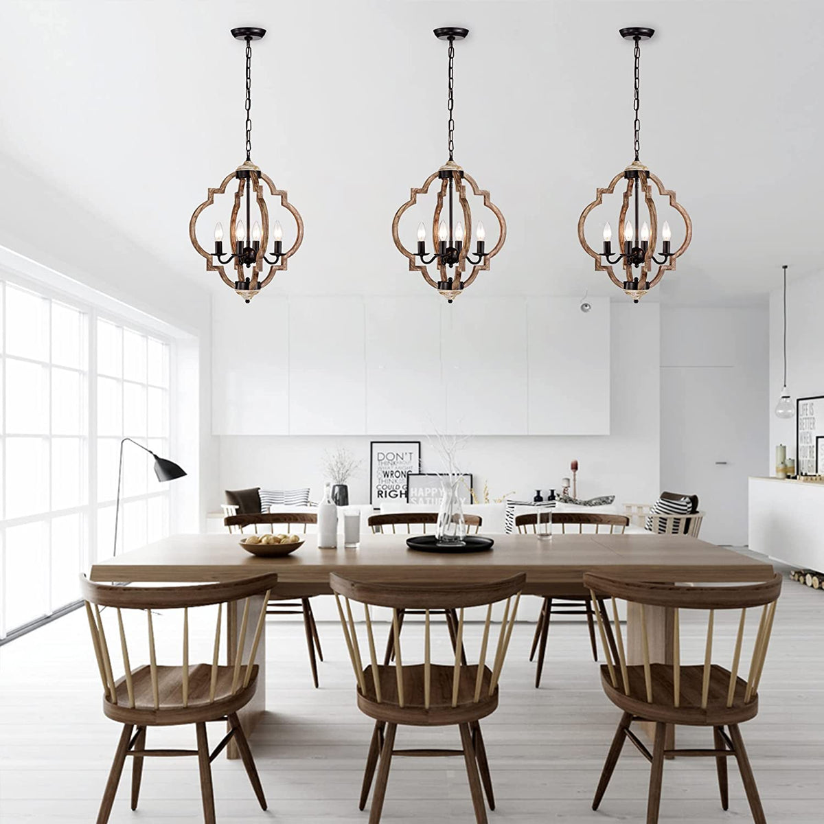 Rustic wooden globe pendant light fixture with four illuminated faux-candle bulbs hanging from a chain.