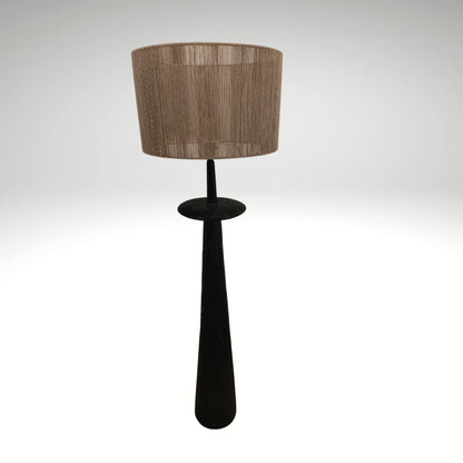 A minimalist sculptural floor lamp showcasing a matte black textured column base paired with a beige string-detailed lampshade.