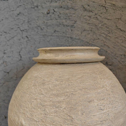 Minimalist wooden display risers holding handcrafted white clay vases in a multi-level arrangement.