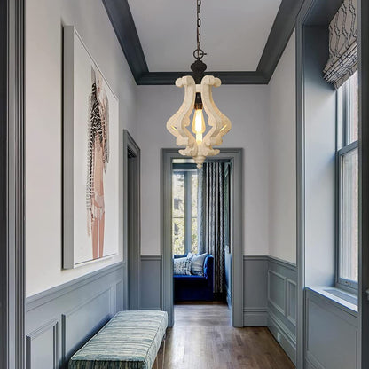Distressed rustic wood scroll pendant light fixture with a warm vintage Edison bulb.