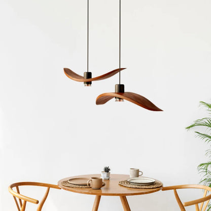 Minimalist Scandinavian ceiling chandelier featuring four bird-wing-shaped natural wood shades dangling at adjustable heights.