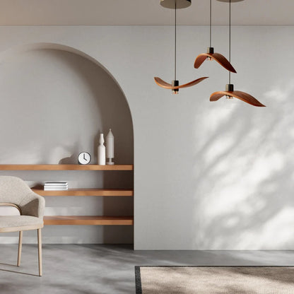 Minimalist Scandinavian ceiling chandelier featuring four bird-wing-shaped natural wood shades dangling at adjustable heights.
