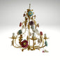 Shabby chic floral chandelier featuring porcelain roses and gold branching arms.