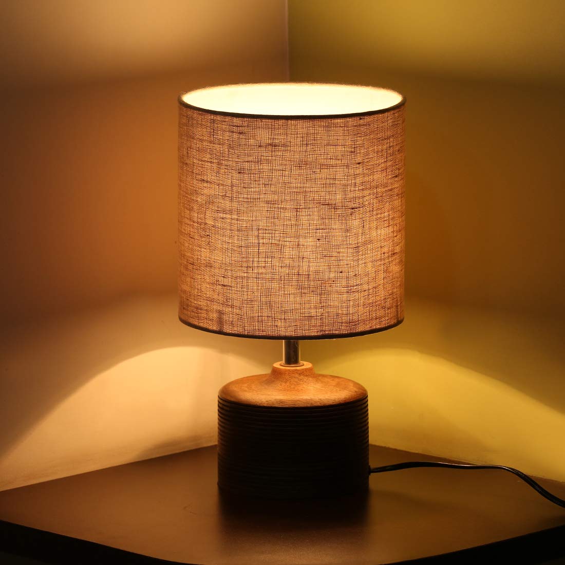 Minimalist rustic wooden bedside table lamp with grooved base detail and textured fabric shade, ideal for living room and bedroom decor.