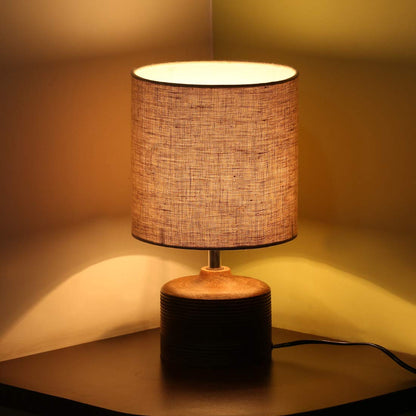 Minimalist rustic wooden bedside table lamp with grooved base detail and textured fabric shade, ideal for living room and bedroom decor.