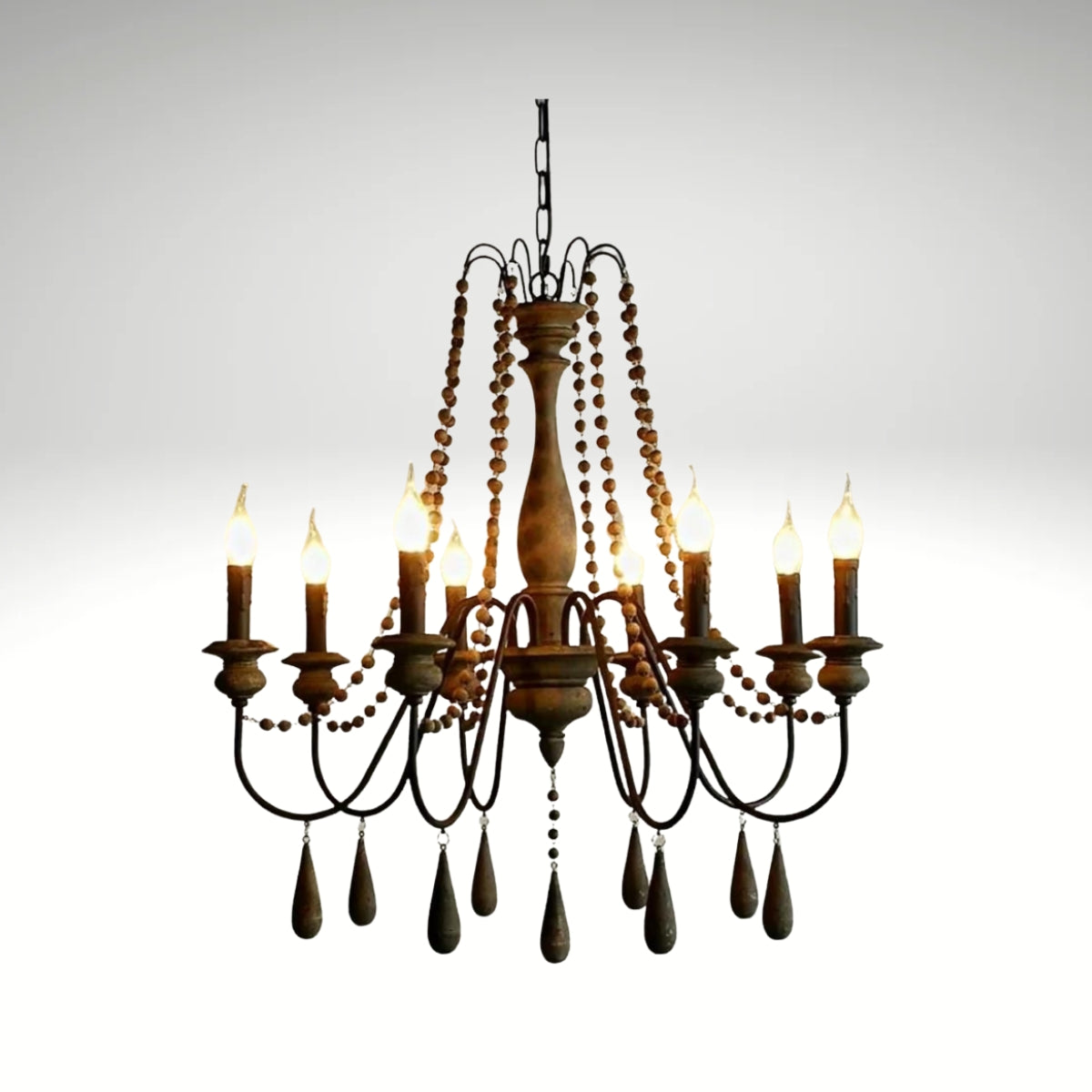 Antique candle-style farmhouse chandelier featuring dark wood finishes and bead strands.