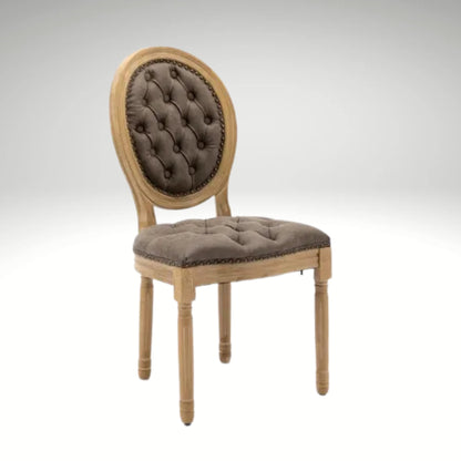 Classic French country dining chair featuring brown tufted cushions and distressed wooden legs.