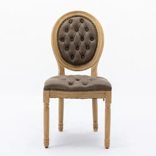 Classic French country dining chair featuring brown tufted cushions and distressed wooden legs.