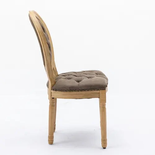 Classic French country dining chair featuring brown tufted cushions and distressed wooden legs.