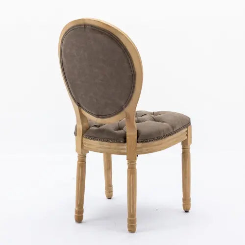 Classic French country dining chair featuring brown tufted cushions and distressed wooden legs.