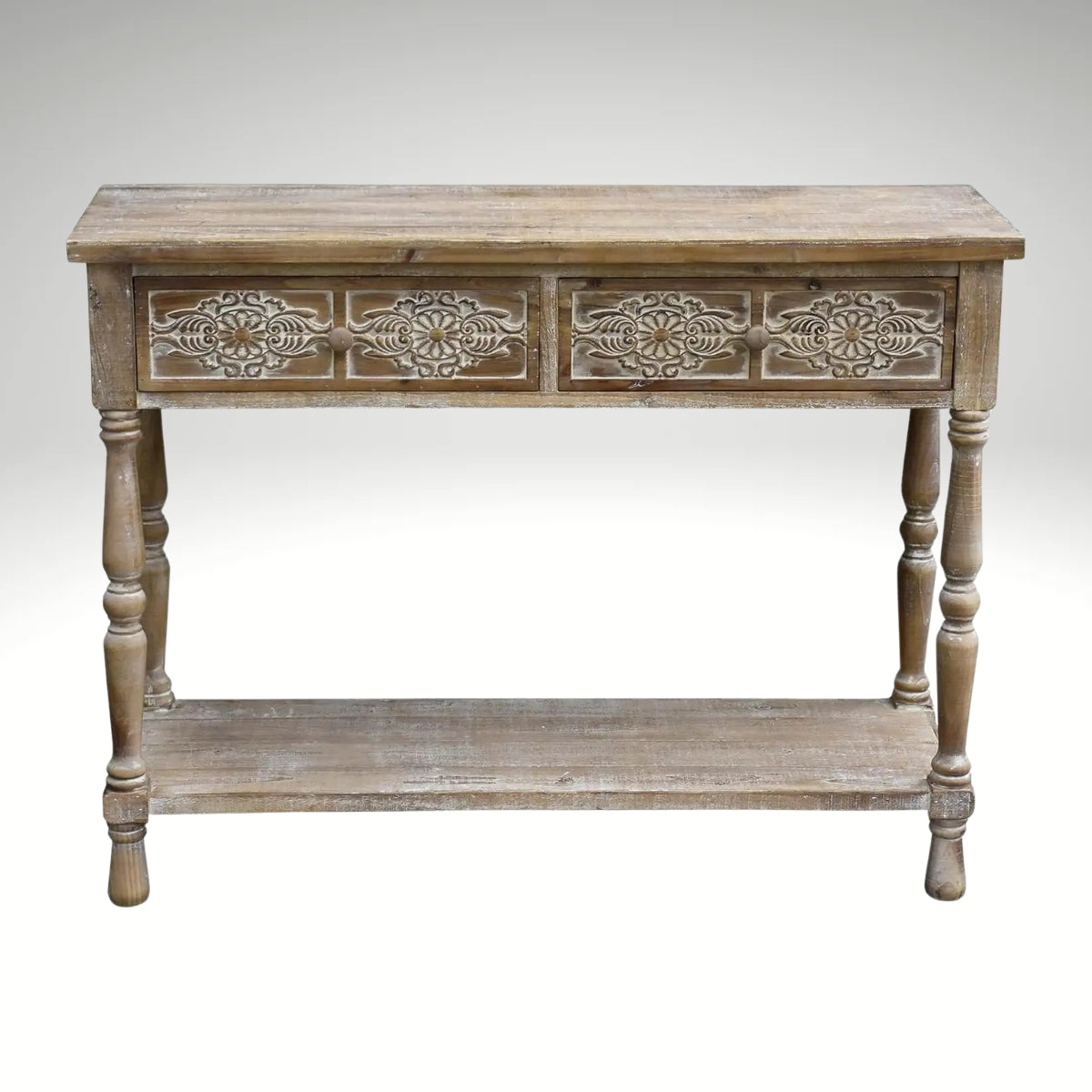 Vintage distressed wood entryway table featuring two drawers with decorative carved panels and a lower open shelf.