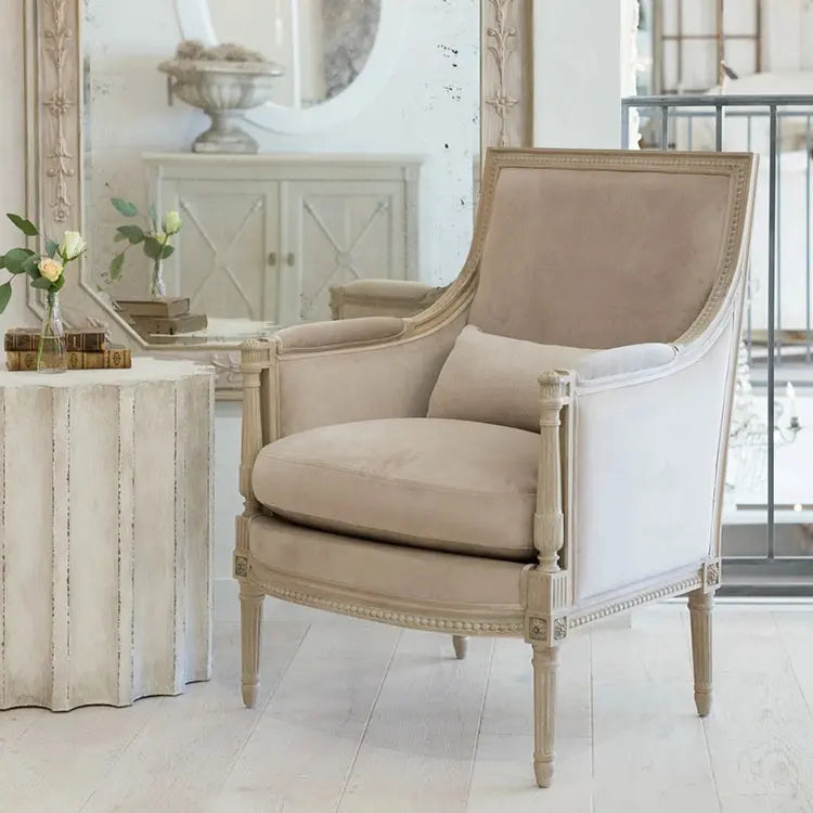 Vintage-style cream accent armchair with a padded seat and backrest.