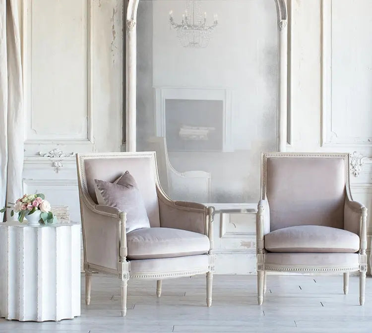 Vintage-style cream accent armchair with a padded seat and backrest.