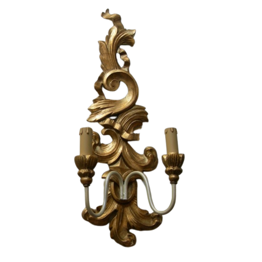 Ornate gold baroque wall sconce with a dual candle light fixture.
