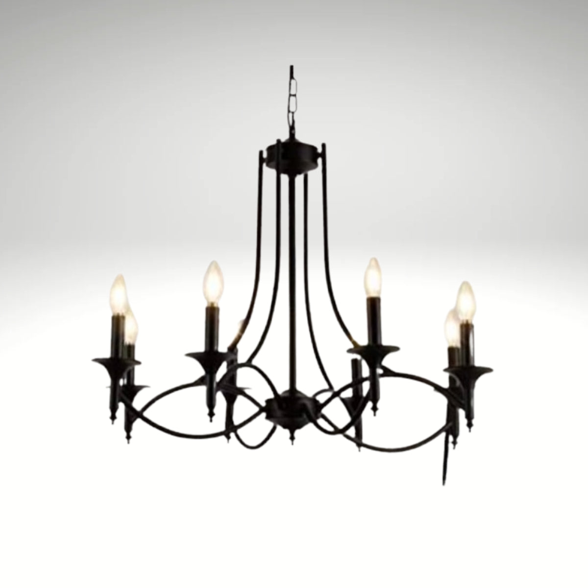 Elegant black wrought iron candelabra chandelier with six glowing bulb lights hanging from a chain against